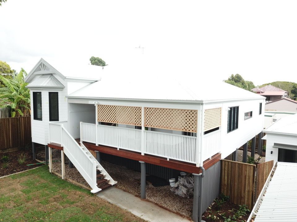 An Aerial View Of A White House With A Balcony And Stairs โ Harrison Development Group In Surfers Paradise, QLD