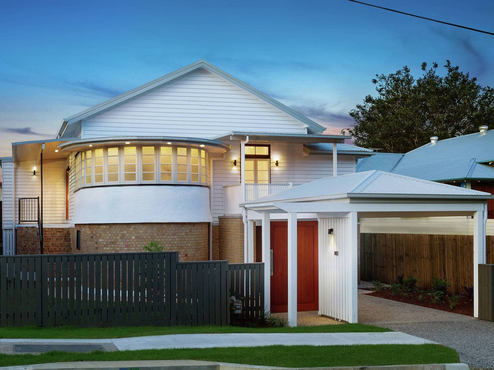 A White House With A Red Door And A Black Fence — Harrison Development Group In Surfers Paradise, QLD