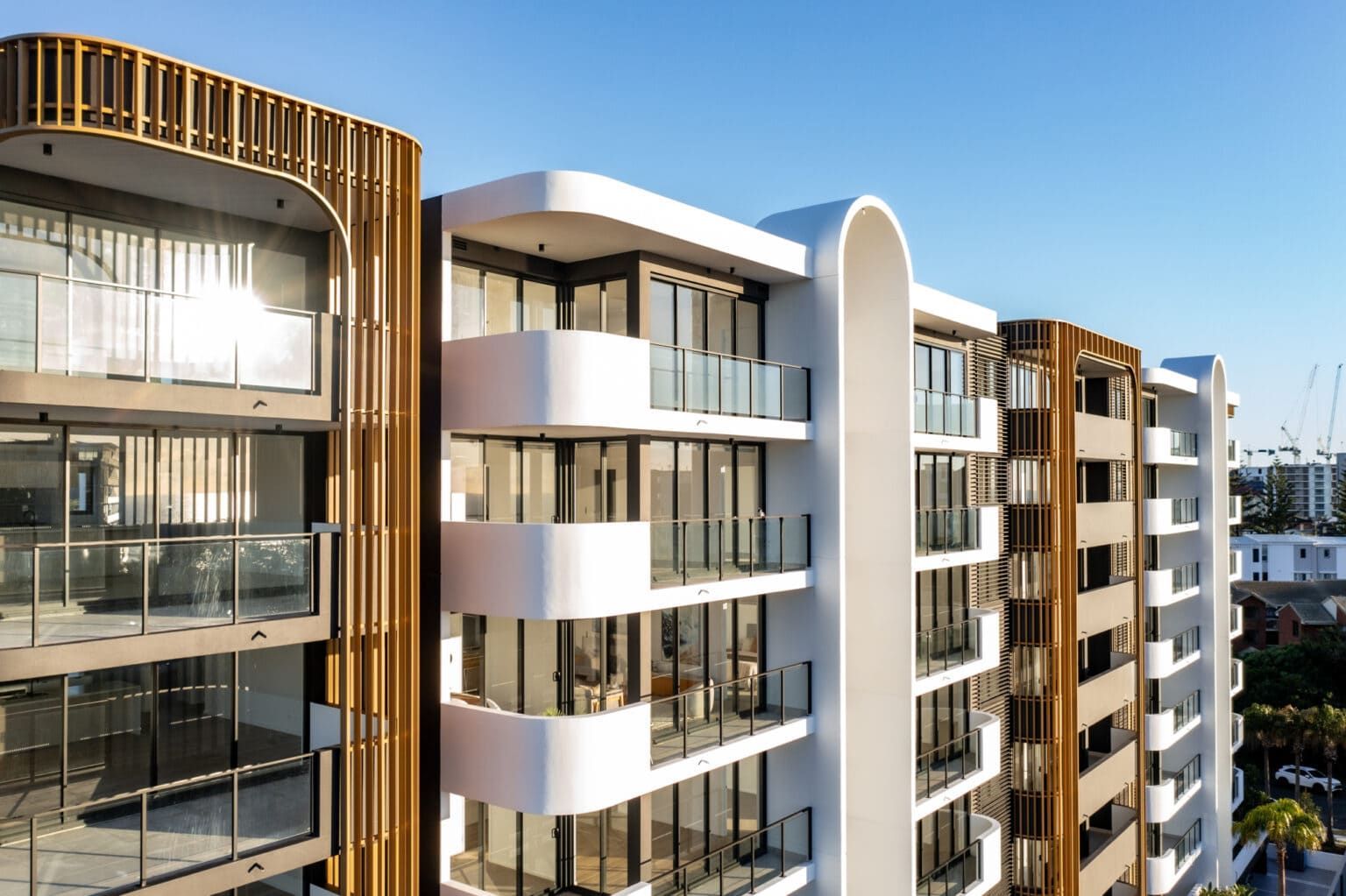 A Large Building With A Lot Of Windows And Balconies — Harrison Development Group In Surfers Paradise, QLD