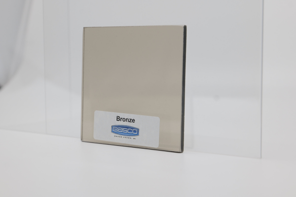 Bronze-colored metal sample with a label reading 