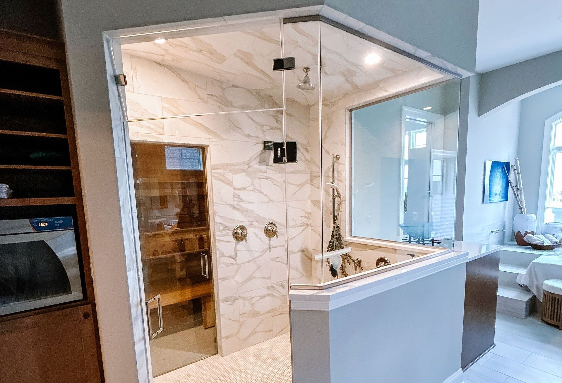 Luxurious bathroom with glass shower enclosure, marble walls, and built-in sauna.