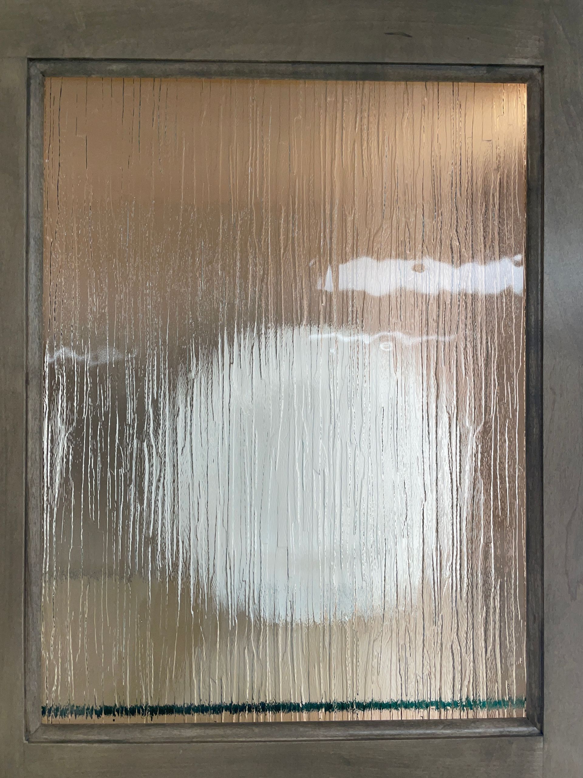 Textured glass panel with streaks, a large white cloud shape, and a horizontal green line.