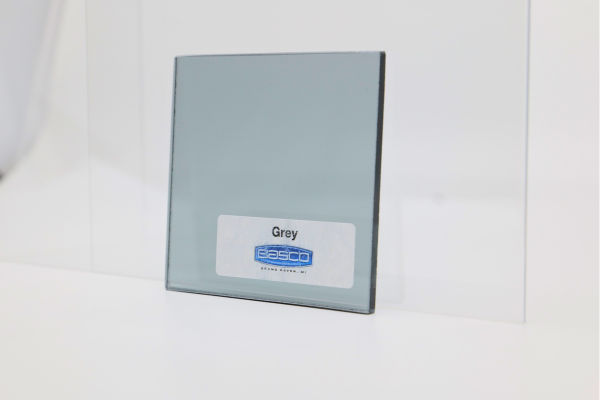 Gray glass panel with a sticker, standing against a white backdrop.