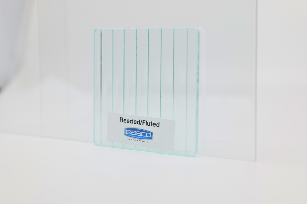 Clear glass sample with vertical fluted pattern; a label reads 