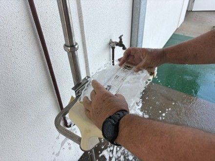 RPS Fire technician checking an emergency eye wash spray pattern with an eyewash gauge