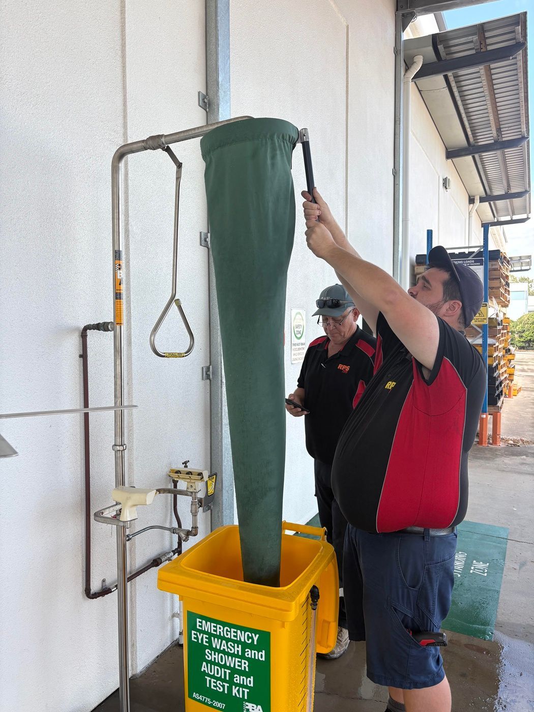 RPS Fire technicians flow testing an emergency safety shower into a calibrated AS 4775 test bin