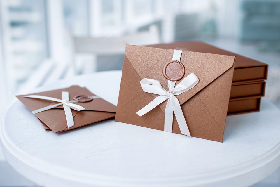 brown envelope wrapped to the white ribbon