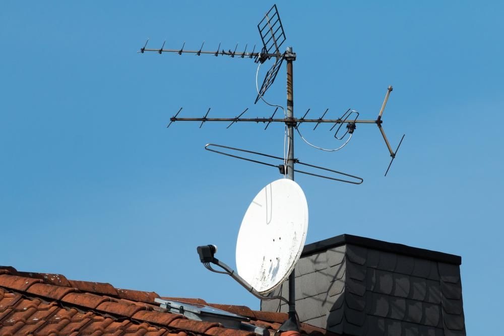 A Satellite Dish Is Sitting On Top Of A Roof — Highfields Antennas In Cabarlah, QLD