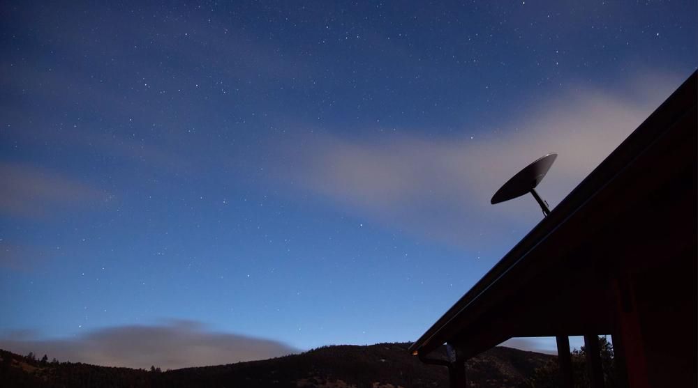 A Satellite Dish On The Roof Of A House At Night — Highfields Antennas In Blackbutt, QLD