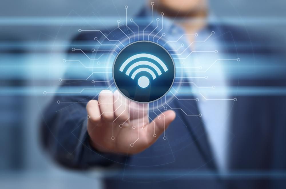 A Man In A Suit Is Touching A Wifi Icon On A Screen — Highfields Antennas In Clifton, QLD