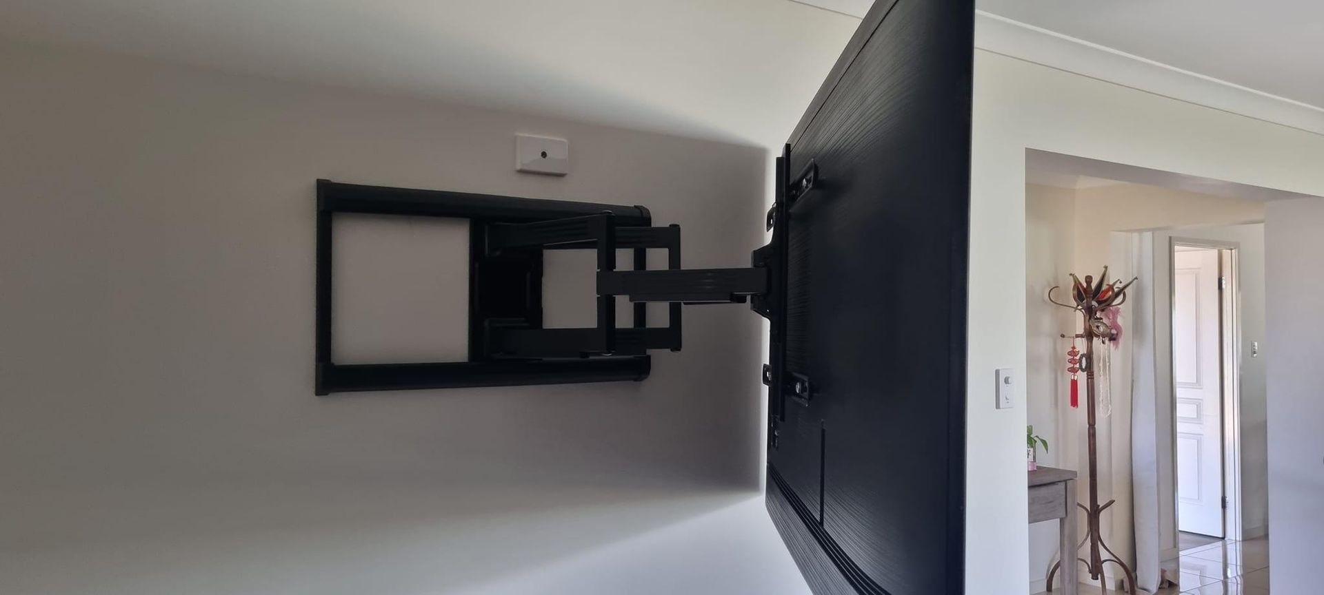 A Flat Screen Tv Mounted On A Wall In A Living Room — Highfields Antennas In Crows Nest, QLD
