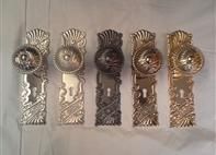 a group of door knobs are sitting next to each other on a table .