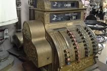 an old cash register is sitting on a table in a room .
