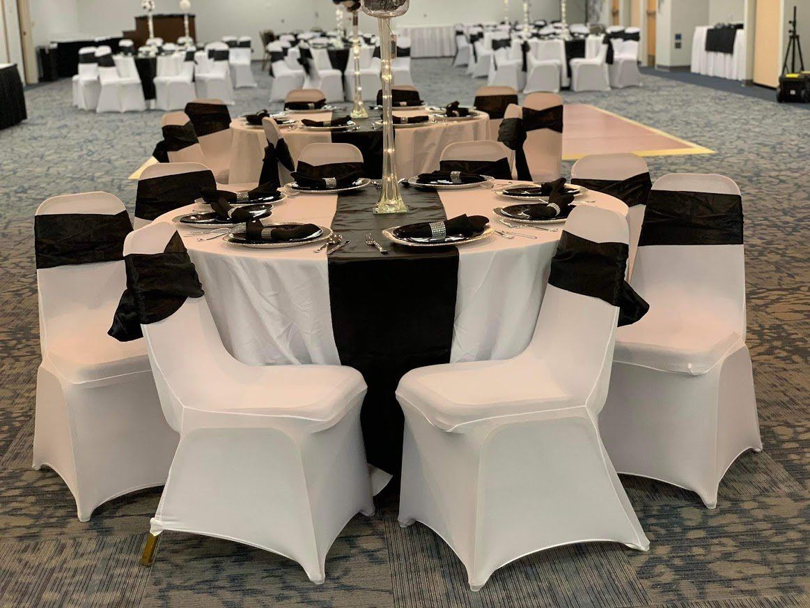 Round banquet tables with black and white chairs in a conference hall