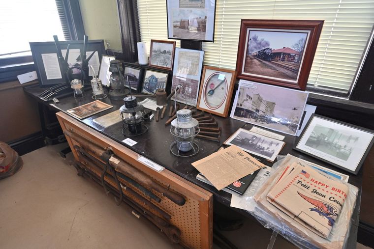 Interior of the Conway County History Museum gallery with wooden display cases and historical photographs