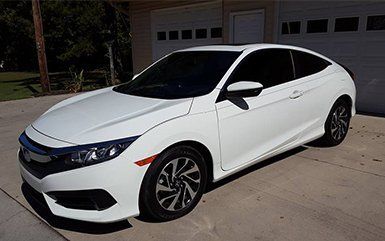 White car in from of the garage