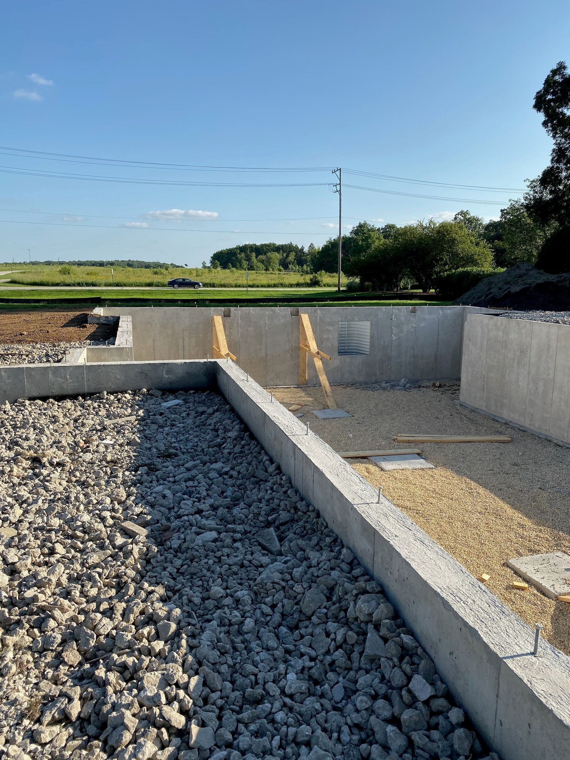 A concrete foundation is being built on top of gravel.