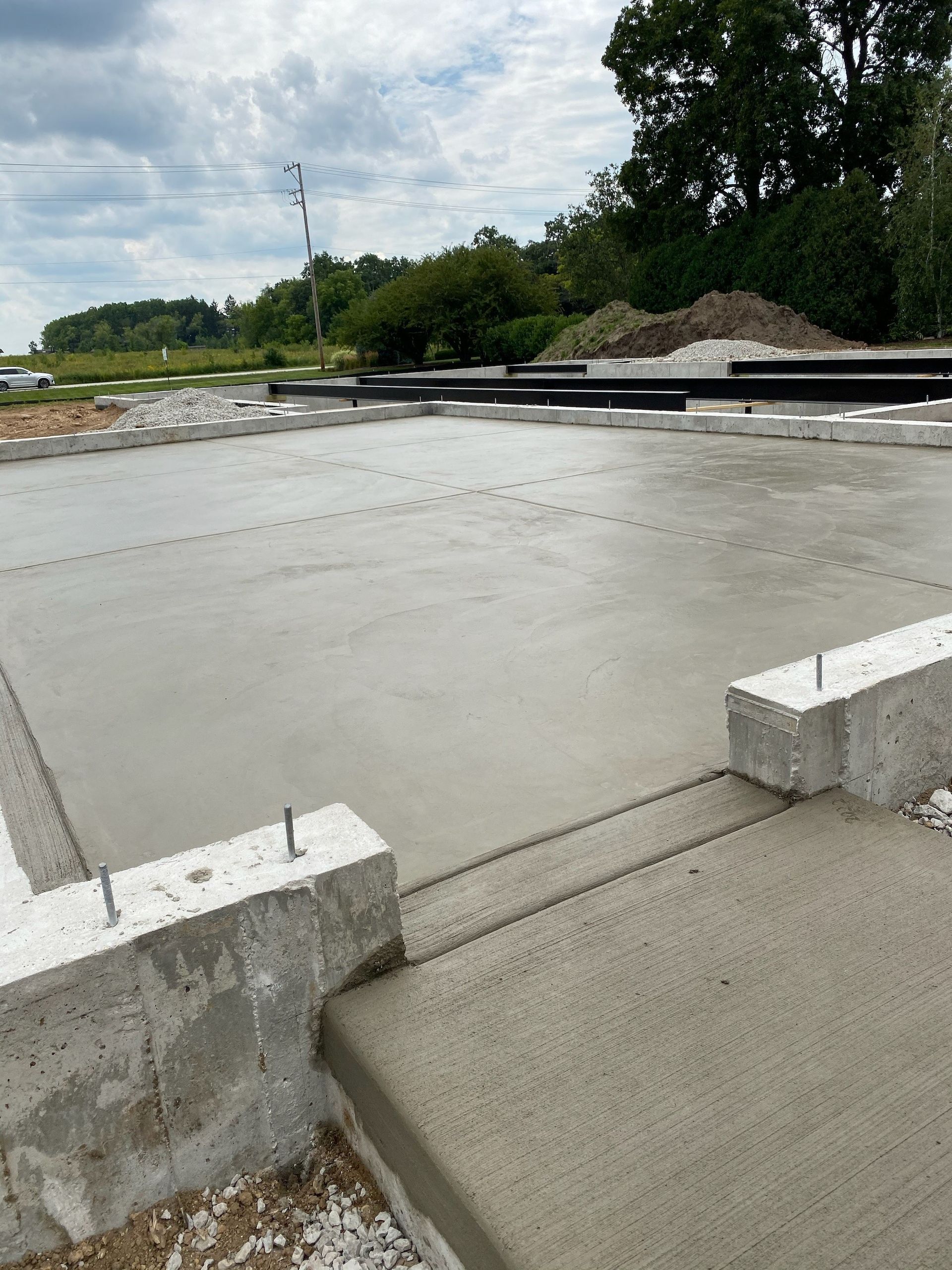A concrete floor is being built on a construction site