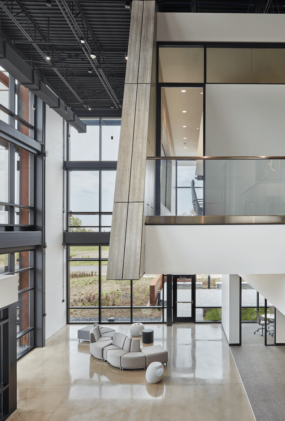 A large building with a lot of windows and a couch in the middle of the room.