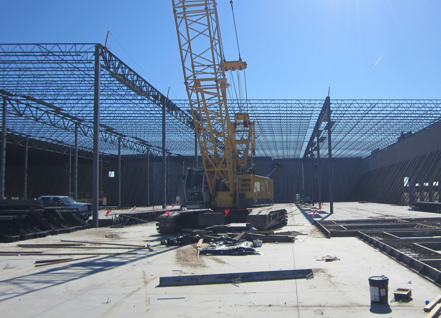 A construction site with a large yellow crane in the middle