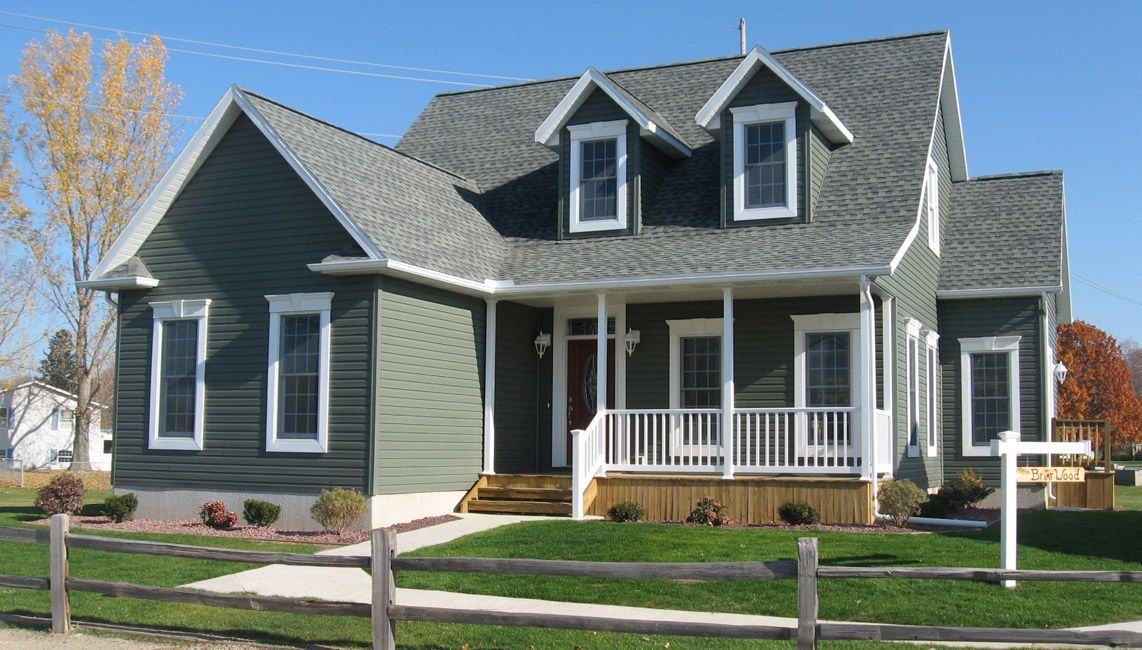 A large house with a wooden fence in front of it