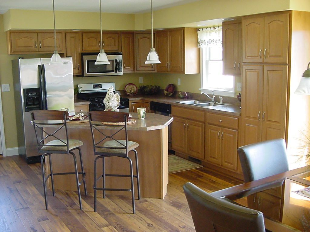 A kitchen with wooden cabinets and stainless steel appliances