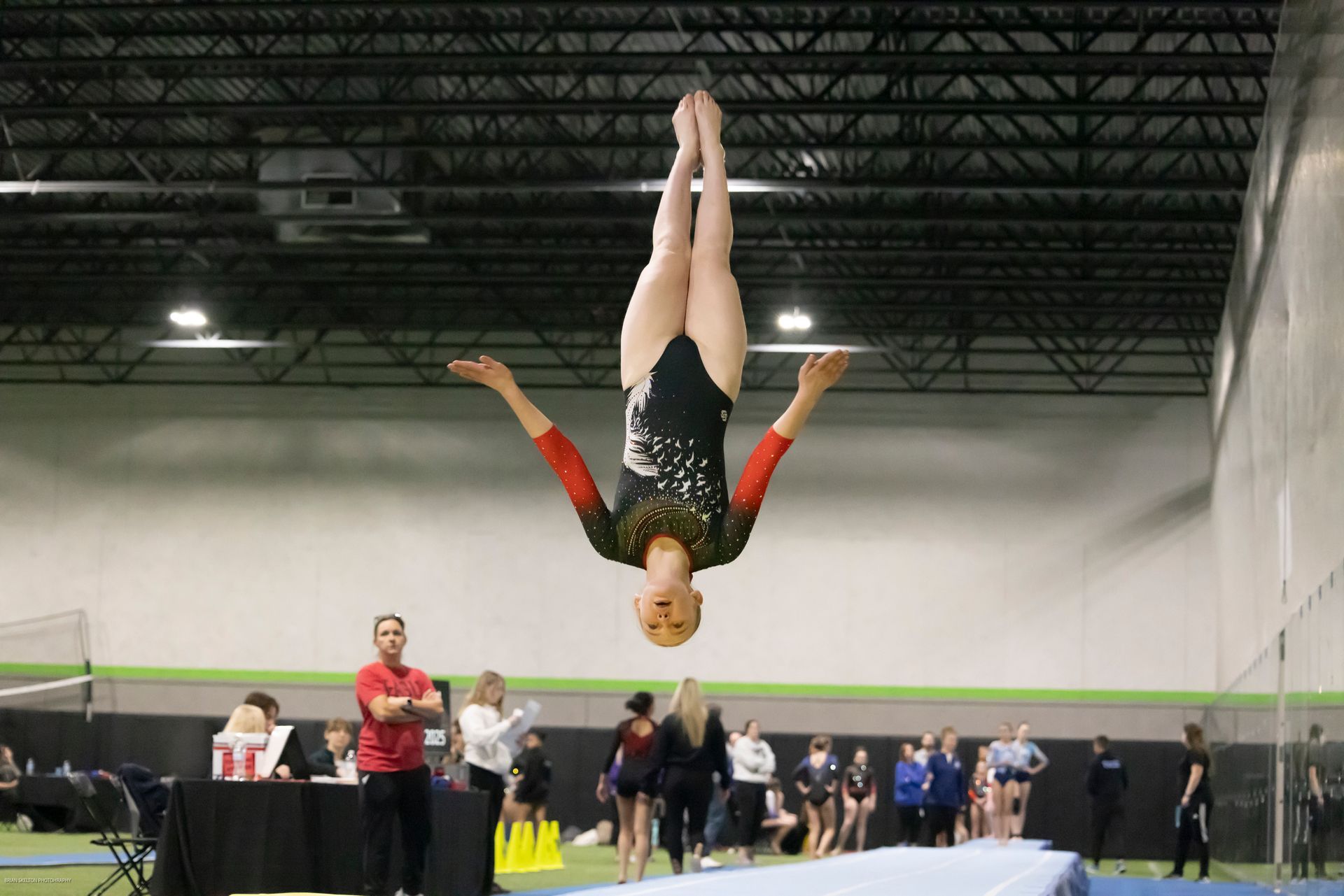 A man and a woman are standing next to each other on a balance beam.