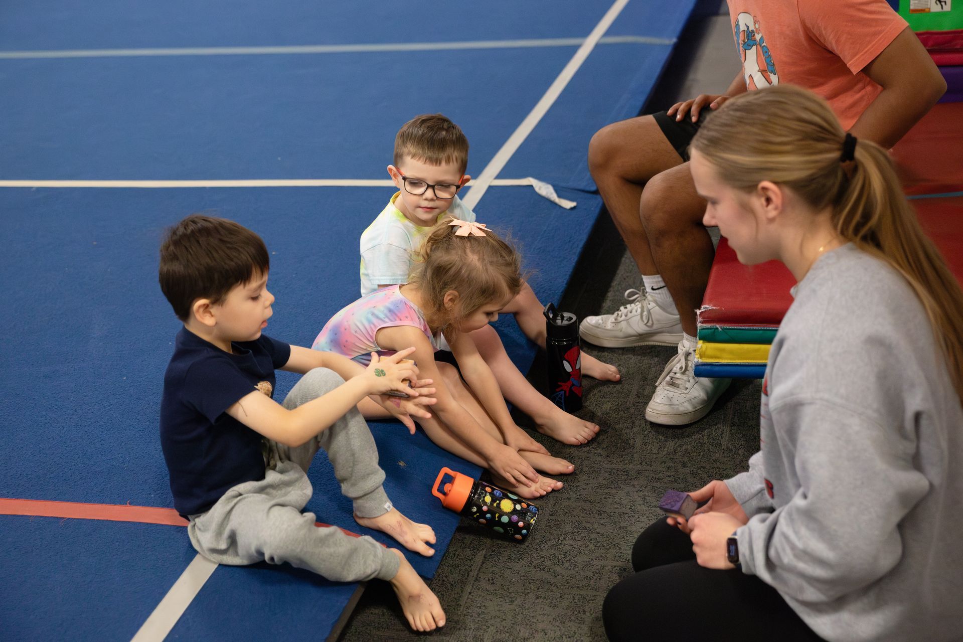 A group of female gymnasts are giving each other a high five.