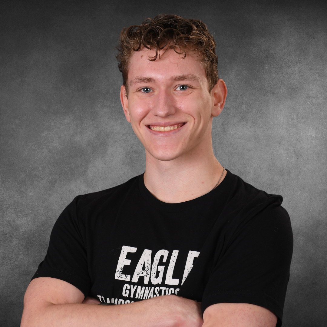 A young man wearing a black shirt that says eagle on it