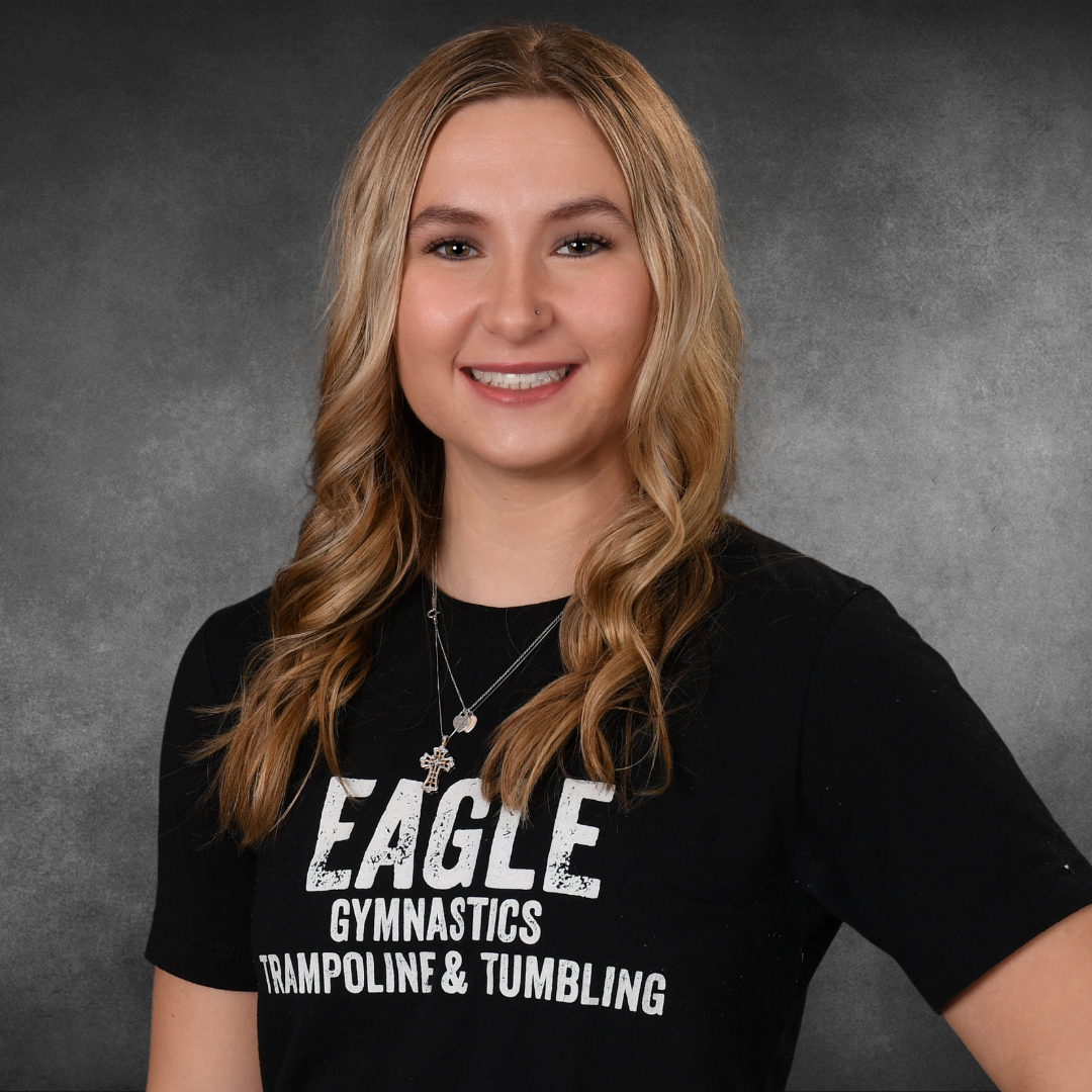 A girl wearing an eagle gymnastics trampoline and tumbling shirt