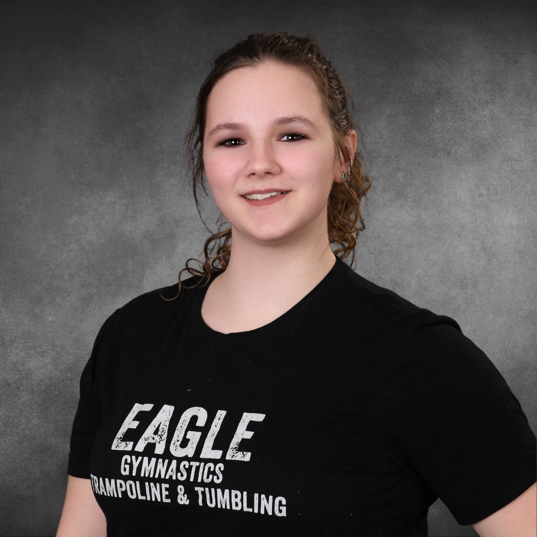 A girl wearing an eagle gymnastics trampoline and tumbling shirt