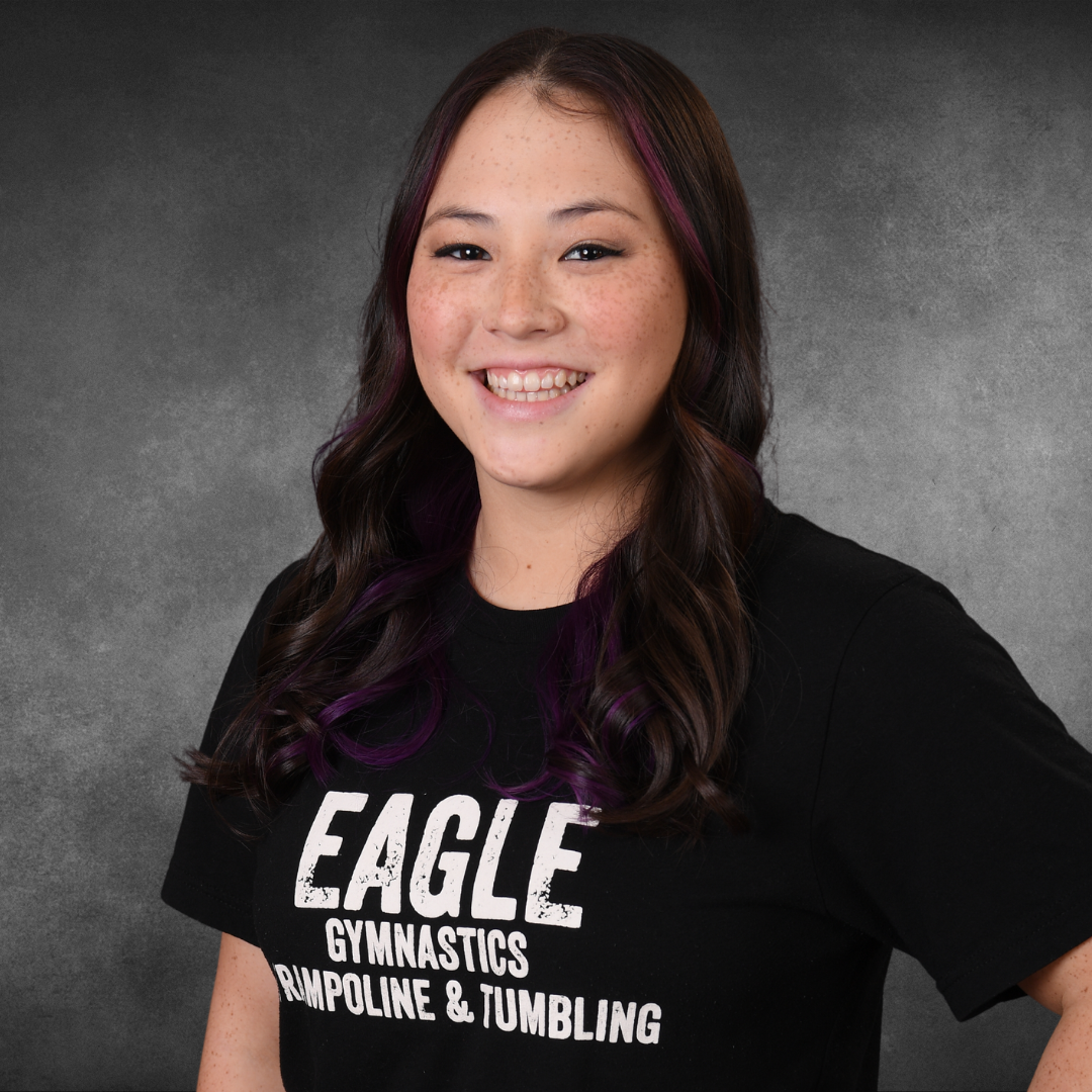 A woman wearing an eagle gymnastics trampoline and tumbling shirt