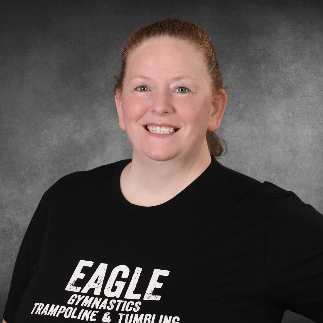 A woman wearing an eagle gymnastics trampoline and tumbling shirt