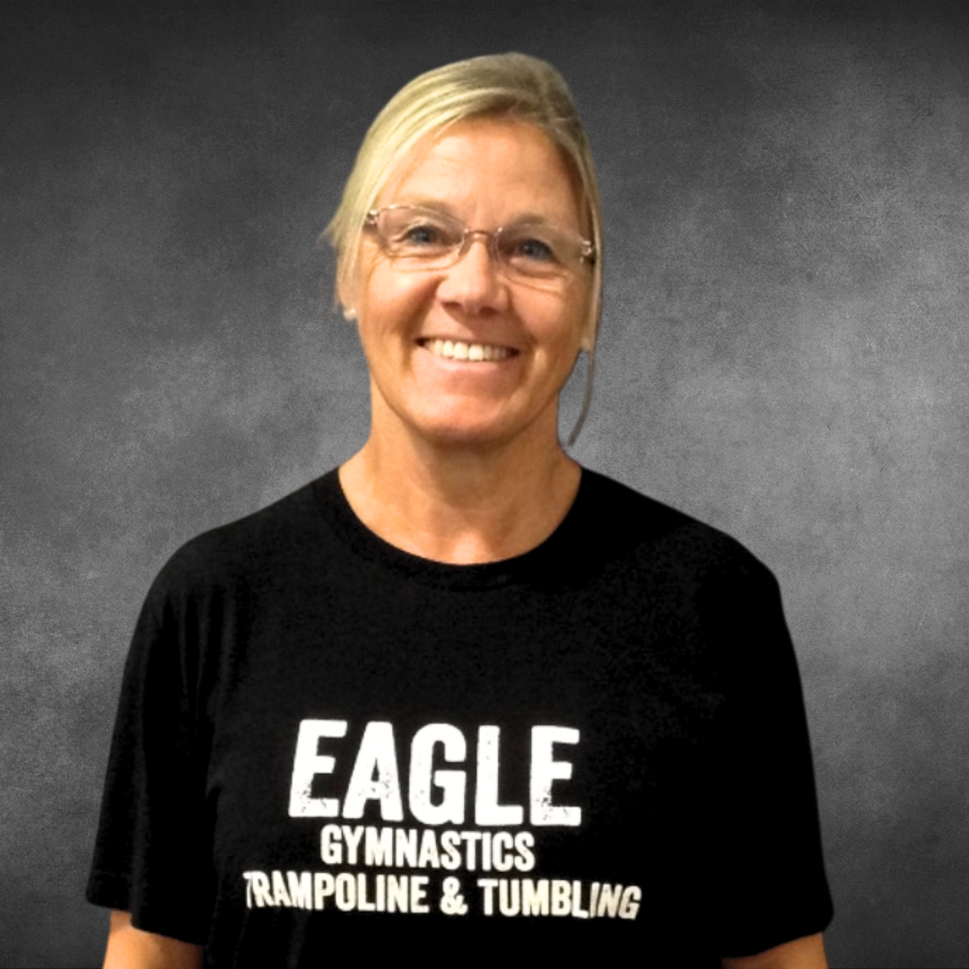 A woman wearing a black eagle gymnastics trampoline and tumbling shirt