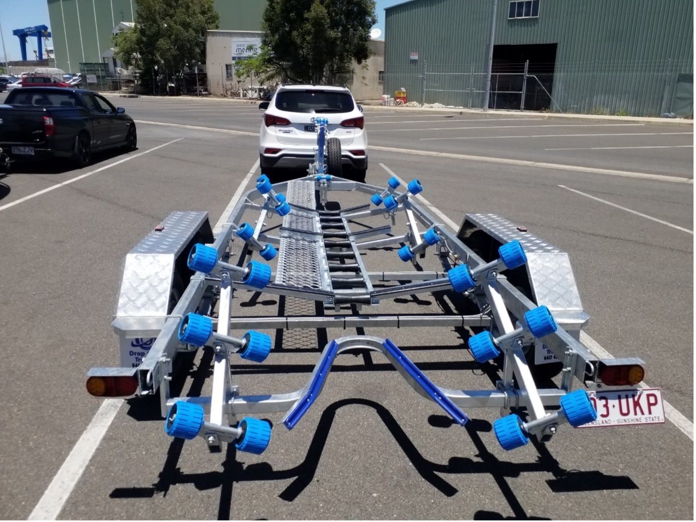 Boat Trailer Being Towed By A Car — Drop Deck Trailers In Urangan QLD