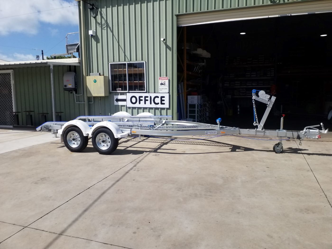 A Trailer Is Parked in Front of A Office — Drop Deck Trailers In Urangan, QLD