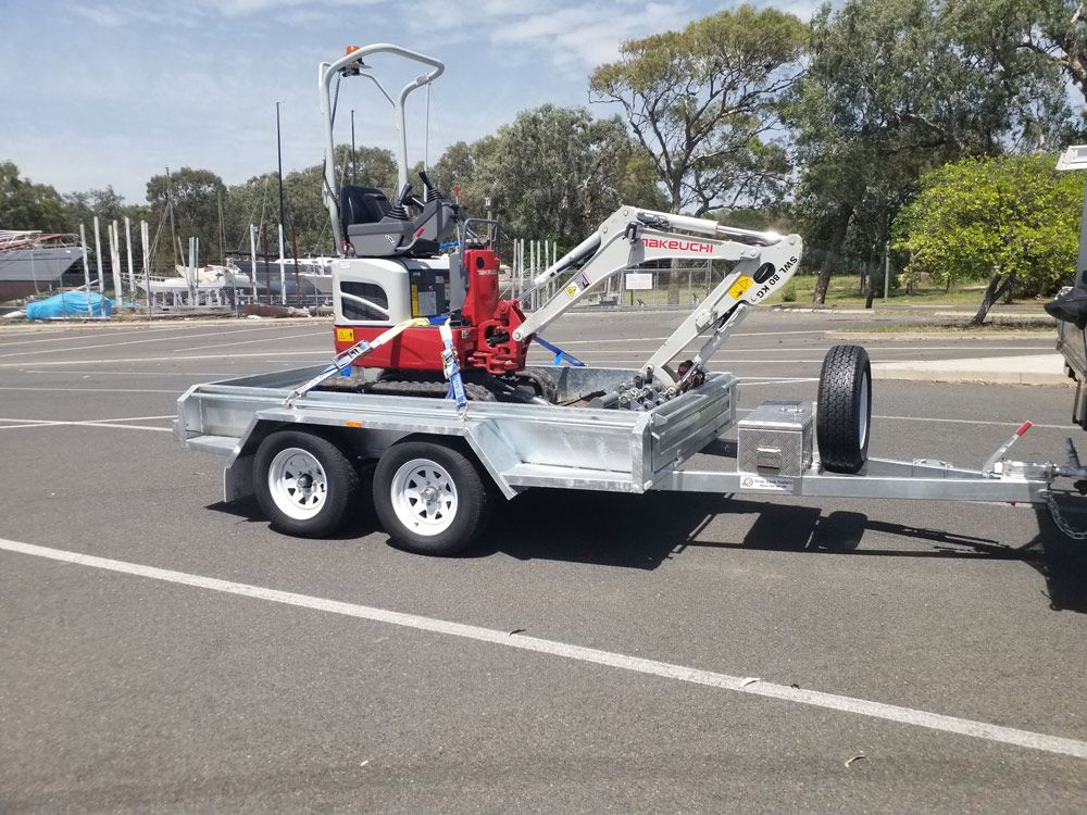 Machinery Equipment On The Car Trailer — Drop Deck Trailers In Urangan QLD