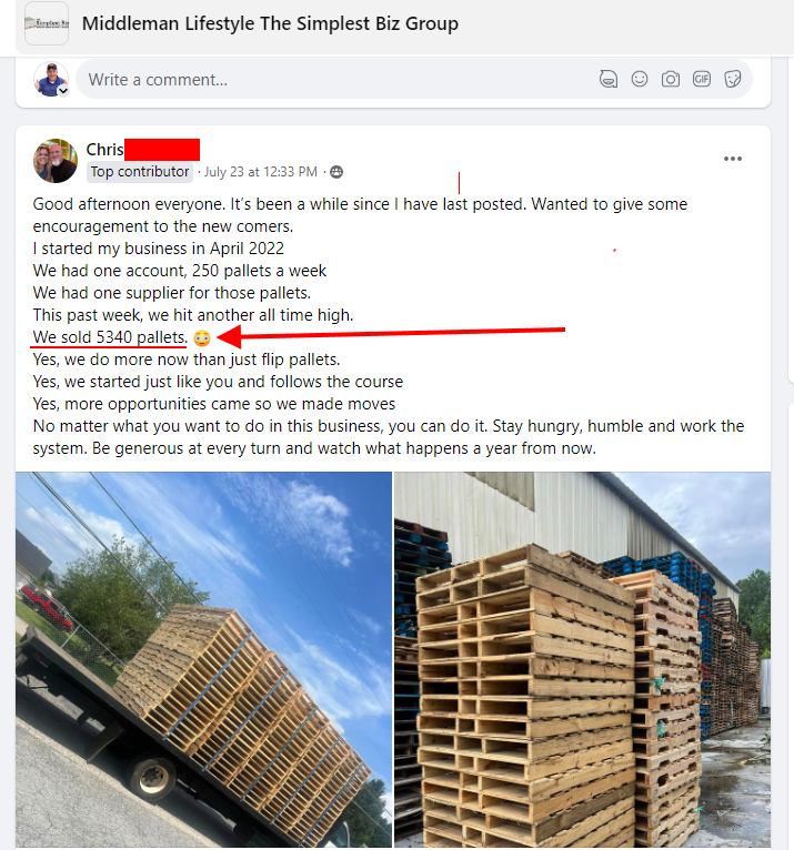A stack of wooden pallets is sitting in front of a building.