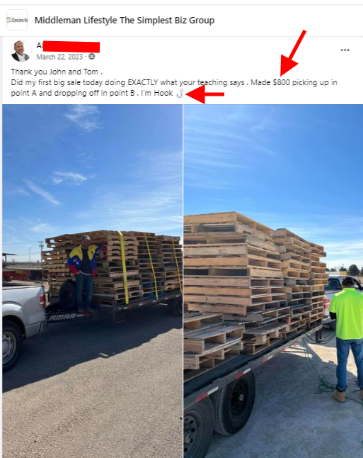 A man is loading wooden pallets onto a truck