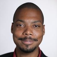 A smiling man with a beard and mustache—proud pallet student thriving with insights from The Simplest Biz Training