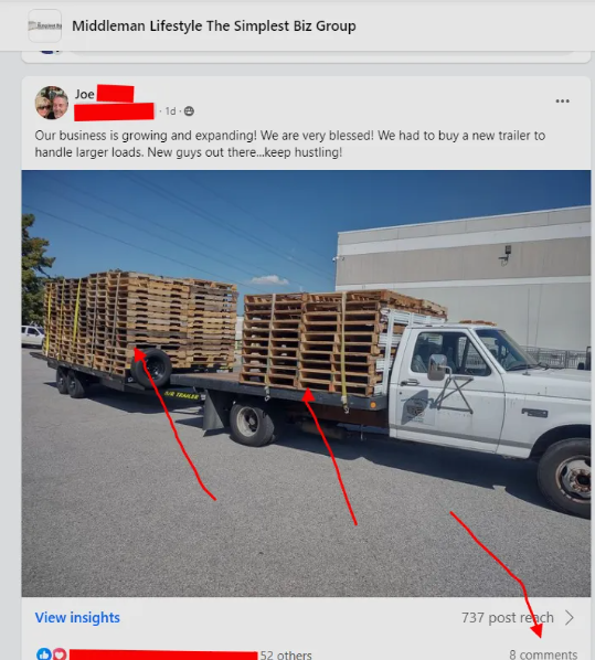 A white truck with wooden pallets on the back of it