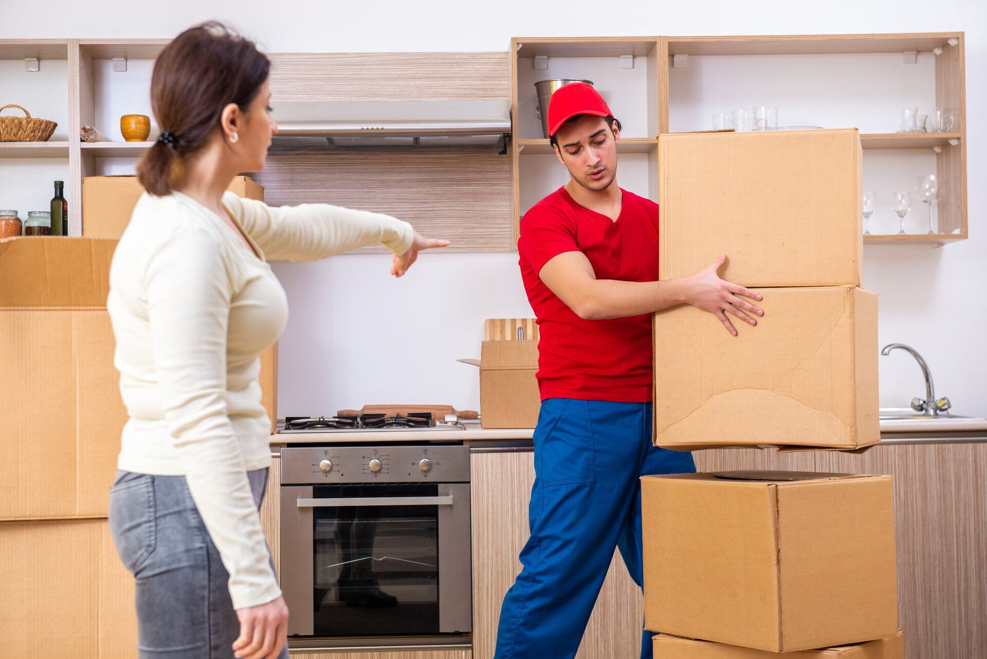 woman pointing at man positioning boxes