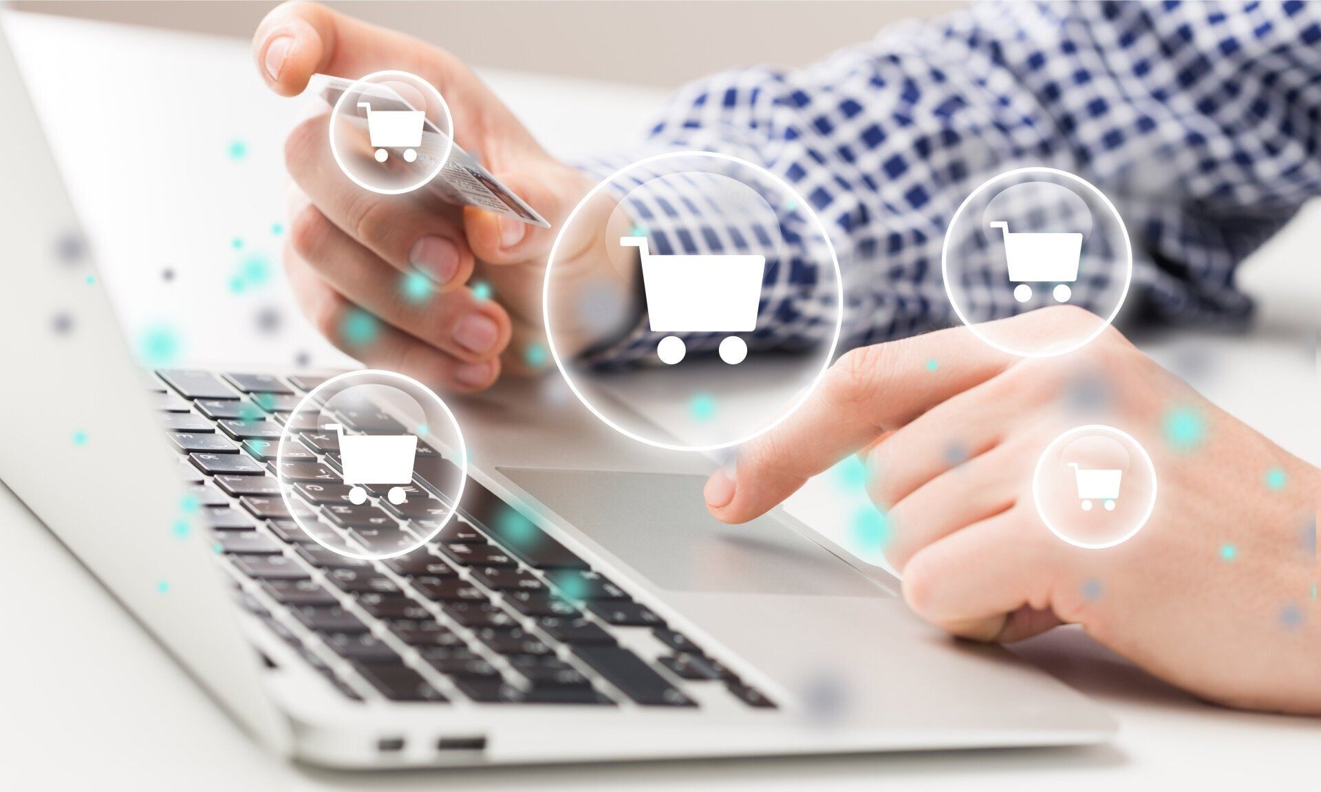 shopping bubbles icons hovering over a laptop indicating a e-commerce website, shopping