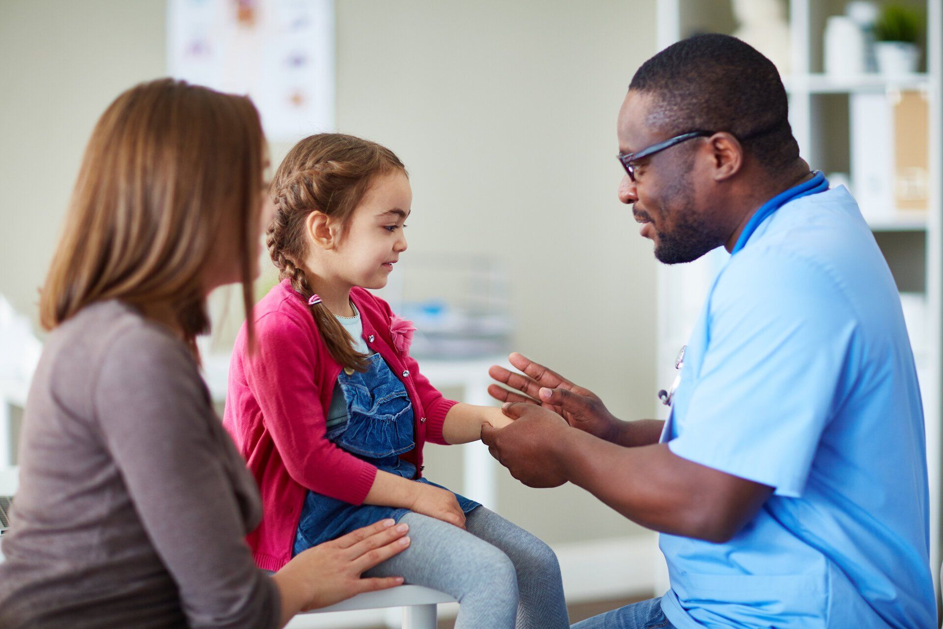 medical working helping little girl