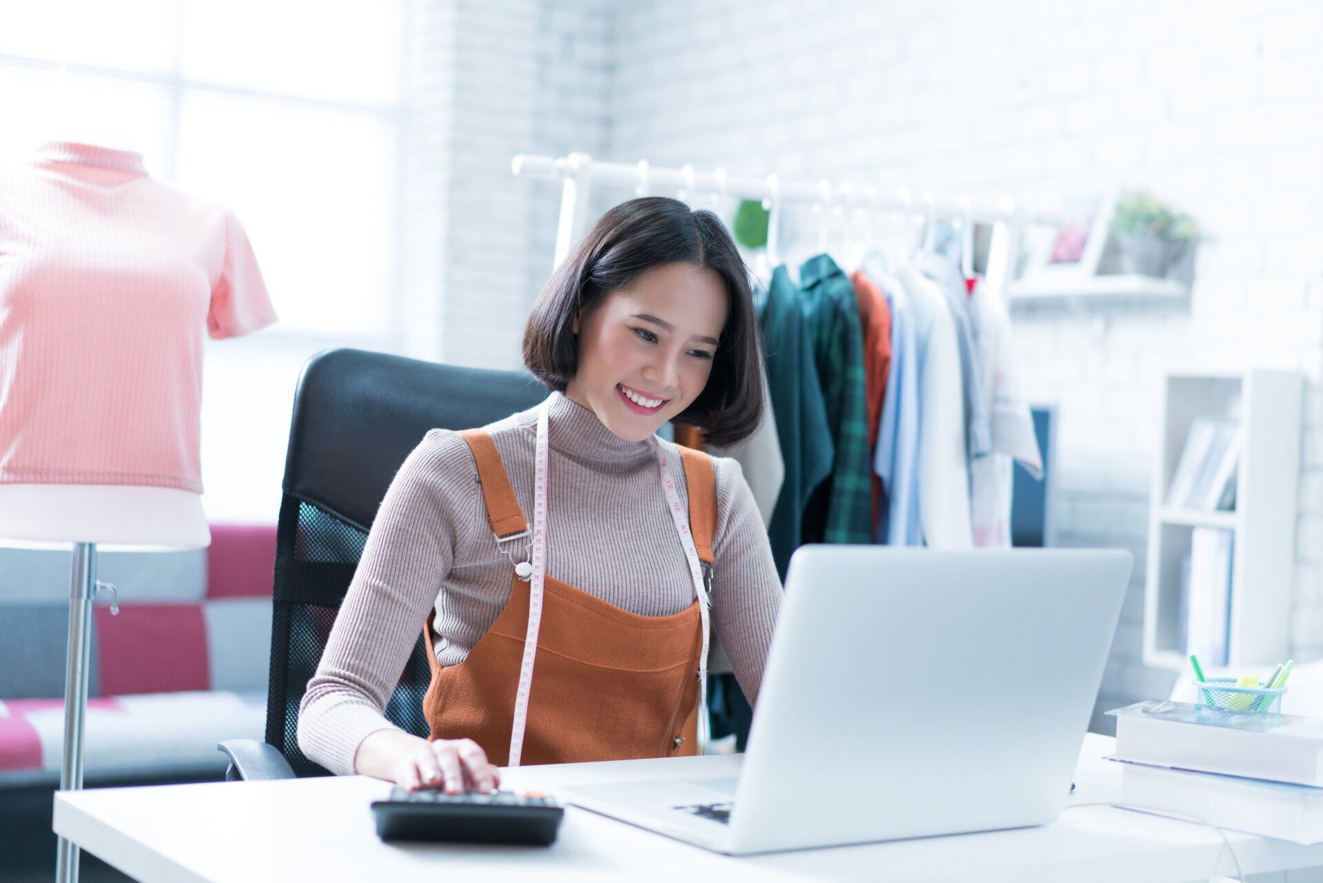happy business owner looking on her computer