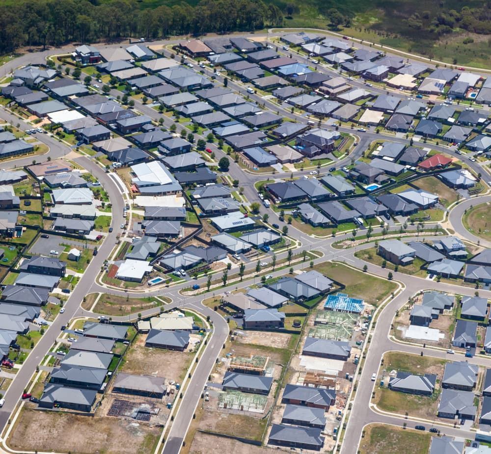 An Aerial View of a Residential Area With Lots of Houses and Roads — Roof Restoration Masters In Fletcher, NSW