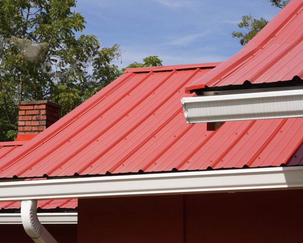 A Red Roof With a White Gutter and a Chimney — Roof Restoration Masters In Thornton, NSW