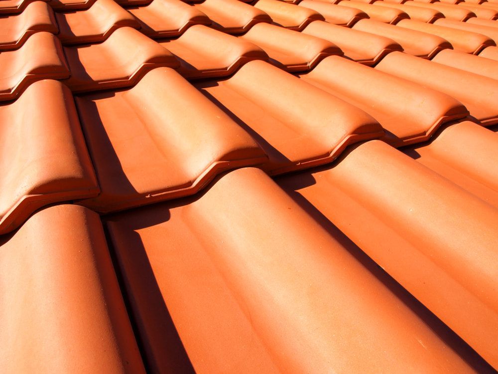 A Close Up of a Row of Orange Tiles on a Roof — Roof Restoration Masters In Central Coast, NSW