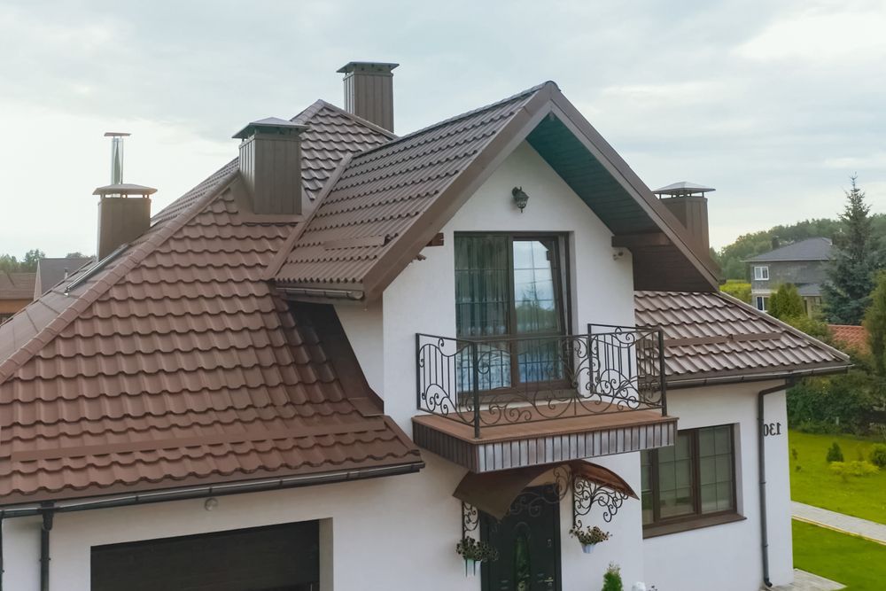 A White House With a Brown Roof and a Balcony — Roof Restoration Masters In Budgewoi, NSW