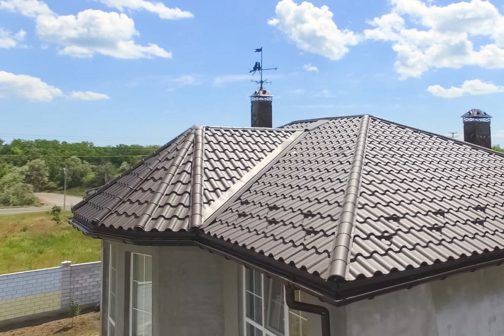 An Aerial View of a House With a Tiled Roof and a Chimney — Roof Restoration Masters In Budgewoi, NSW